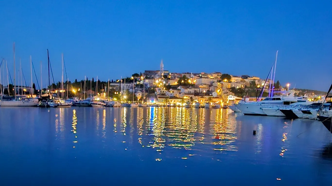 Vrsar harbour and old town at dusk