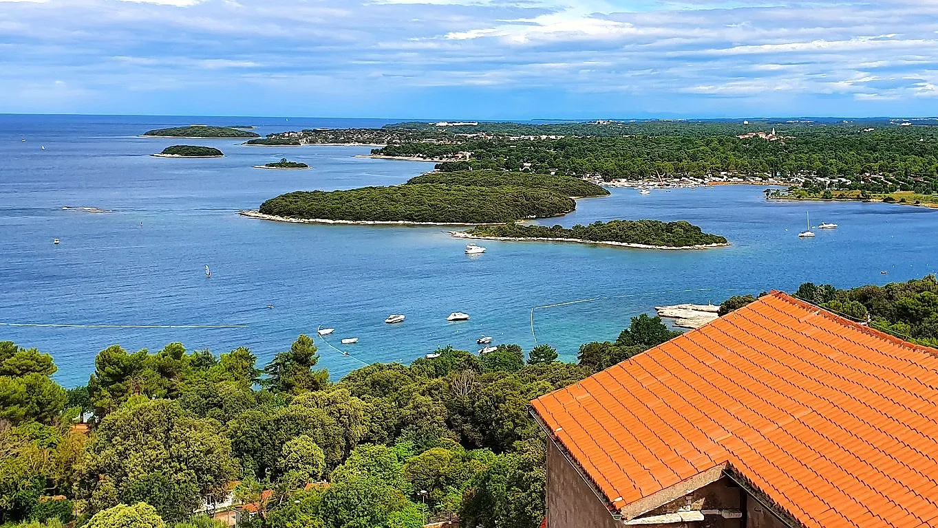 Sea and islets seen over the old-town rooftops