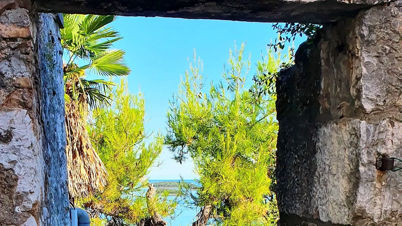 Sea view through a stone arch